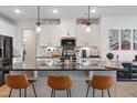 Modern kitchen featuring stone counters, a kitchen island, and stainless steel appliances at 1104 Briar Gate Dr, Holly Springs, NC 27540