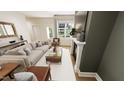 Bright living room featuring a stylish sofa, modern fireplace, large window, and neutral decor at 111 Weavers Grv Dr, Chapel Hill, NC 27514