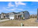 Charming home featuring a two-car garage and landscaped front yard at 1206 Newton Dr Dr, Mebane, NC 27302