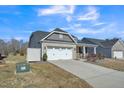 Charming home featuring a two-car garage and landscaped front yard at 1206 Newton Dr Dr, Mebane, NC 27302