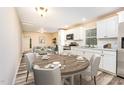 Eat-in kitchen featuring white cabinets, stainless steel appliances, and modern flooring at 121 Lena Ct, Burlington, NC 27217