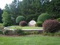 Well-landscaped entrance to Oxford Park neighborhood features a brick sign and vibrant flowerbeds at 126 Kipling Dr, Oxford, NC 27565