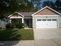 Beautiful single-story house featuring a well-manicured lawn and attached two-car garage at 126 Kipling Dr, Oxford, NC 27565
