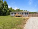Home with a wooden porch, classic shutters, and gravel driveway at 130 Ruby Trl, Roxboro, NC 27574