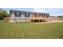 Charming single-Gathering home with a front porch and a spacious green lawn at 130 Ruby Trl, Roxboro, NC 27574