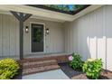 A close-up view of the front porch shows brick steps leading to a dark front door with sidelight accents at 1308 Broken Branch Ct, Raleigh, NC 27610