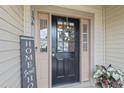 Inviting front entry featuring a black front door with glass and charming decorations at 136 Thornhill Dr, Burlington, NC 27215