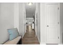 Hallway features neutral walls, and a bench with a pillow. Visible doorways to rooms at 136 Thornhill Dr, Burlington, NC 27215