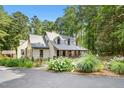 Inviting two-story home with a covered porch and well-manicured garden, blending comfort and natural beauty at 139 Trillium Pl, Chapel Hill, NC 27517