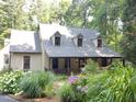 Beautiful home with front porch and landscaped yard featuring hydrangeas, creating inviting curb appeal at 139 Trillium Pl, Chapel Hill, NC 27517