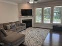 Inviting living room showcases hardwood floors, a cozy fireplace, and large windows for natural light at 146 Verona Villa Dr, Burlington, NC 27215
