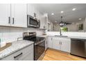 Modern kitchen featuring stainless steel appliances, granite countertops, and white subway tile backsplash at 2001 Turtle Point Dr, Raleigh, NC 27604