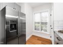 Kitchen featuring stainless steel refrigerator with dispenser and natural light from the window at 2001 Turtle Point Dr, Raleigh, NC 27604