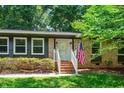 Inviting front entrance with brick steps and a white door, showcasing the home's classic charm at 202 Howland Ave, Cary, NC 27513