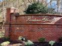 Brick sign for Providence Glen, with manicured landscaping, welcomes visitors to the community at 211 Providence Glen, Chapel Hill, NC 27514