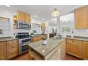 Well-lit kitchen boasting granite countertops, wood cabinetry, stainless steel appliances, and views into the dining room at 2306 Damascus Church Rd, Chapel Hill, NC 27516
