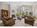 Bright living room with soaring ceilings, large windows, and cozy fireplace at 2419 Rogerson St, Raleigh, NC 27614