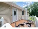 A cozy front porch with seating offers a welcoming entrance to the home at 3012 Optimist Farm Rd, Apex, NC 27539