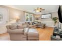 A comfortable living room with neutral tones features a plush sectional and a ceiling fan at 3012 Optimist Farm Rd, Apex, NC 27539