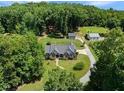 High-angle shot shows the house and guest house and the land around it on a beautiful sunny day at 311 Rassie Crabtree Rd, Rougemont, NC 27572
