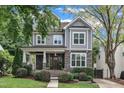 A picturesque two-story home with a covered front porch and beautifully landscaped front yard at 425 Morrison Ave, Raleigh, NC 27608
