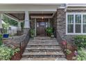 Close up of front entrance with beautiful stone steps and an elegant dark wood door at 425 Morrison Ave, Raleigh, NC 27608