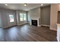 Bright living room featuring a fireplace, neutral paint, and wood floors at 508 Yeowell Dr, Chapel Hill, NC 27514