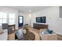 Bright living room with stylish furnishings, TV, blue front door, and a comfortable seating area at 508 Yeowell Dr, Chapel Hill, NC 27514
