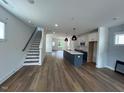 Bright, open-concept living space with wood floors, white cabinets, kitchen island, and modern lighting at 510 Yeowell Dr, Chapel Hill, NC 27514