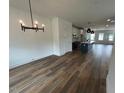 Bright, open-concept living space with wood floors, white cabinets, kitchen island, and modern lighting at 510 Yeowell Dr, Chapel Hill, NC 27514