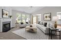 Bright living room showcasing stylish white furnishings, a decorative fireplace, and large windows at 608 Kinship Ln, Apex, NC 27502