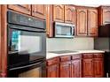 Close up of dark wood cabinets and stainless steel appliances at 8415 Meadow View Ln, Bahama, NC 27503