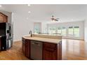 Gourmet kitchen island with stainless steel appliances, eat-in bar and views of the bright living area at 8415 Meadow View Ln, Bahama, NC 27503