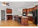Spacious kitchen with a central island, stainless steel appliances and cozy breakfast bar at 8415 Meadow View Ln, Bahama, NC 27503