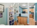 Cozy dining area adjacent to a modern kitchen with warm wood cabinets at 8620 Neuse Club Ln # 107, Raleigh, NC 27616