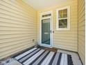 Inviting front porch with a striped rug, perfect for welcoming guests to your new home at 903 Grace Point Rd, Morrisville, NC 27560