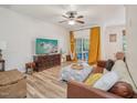 Comfortable living room featuring hardwood floors, ample natural light, and stylish décor at 903 Grace Point Rd, Morrisville, NC 27560