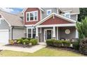 Inviting front porch with decorative wreath, stone accents, and manicured shrubbery at 112 Pearsall Farm Ln, Clayton, NC 27527