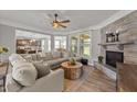 Cozy living room with a stone fireplace, plush sofa, and plenty of natural light at 112 Pearsall Farm Ln, Clayton, NC 27527