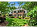Charming brick home features lush green lawn and mature landscaping at 116 Berry Hill Dr, Raleigh, NC 27615