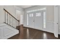 Elegant foyer featuring hardwood floors, staircase, and a beautiful front door with glass panels at 119 Blossom Creek Dr, Garner, NC 27529