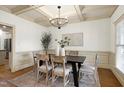 Elegant dining room features a coffered ceiling and stylish chandelier at 1217 Chalk Maple Dr, Cary, NC 27519