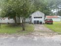 View of the house with a detached garage and a concrete driveway at 1256 Planters St, Rocky Mount, NC 27801
