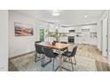 Eat in kitchen with stainless appliances, sleek white cabinets and wood floors at 1621 N Park Ave, Burlington, NC 27217