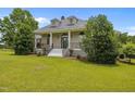 Inviting home boasting a well-manicured lawn, beautiful architectural design, and classic facade at 1672 Wheeler Dr, Angier, NC 27501