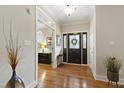 Bright foyer boasts hardwood floors, decorative front door and sidelights, and elegant lighting at 1831 Middlebrook Dr, Raleigh, NC 27615