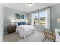 Bright bedroom with two large windows, white bedding, and stylish decor at 2019 Kapalua Way # 200, Durham, NC 27703