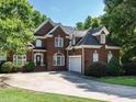 Beautiful two story brick home with manicured lawn, mature landscaping, and an extended driveway at 230 Paula Dr, Angier, NC 27501