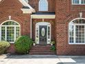 Close up of the front door and entryway, including mature landscaping at 230 Paula Dr, Angier, NC 27501