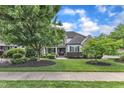 Well-maintained home with a lush green lawn, mature trees, and colorful landscaping at 237 Bendemeer Ln, Rolesville, NC 27571